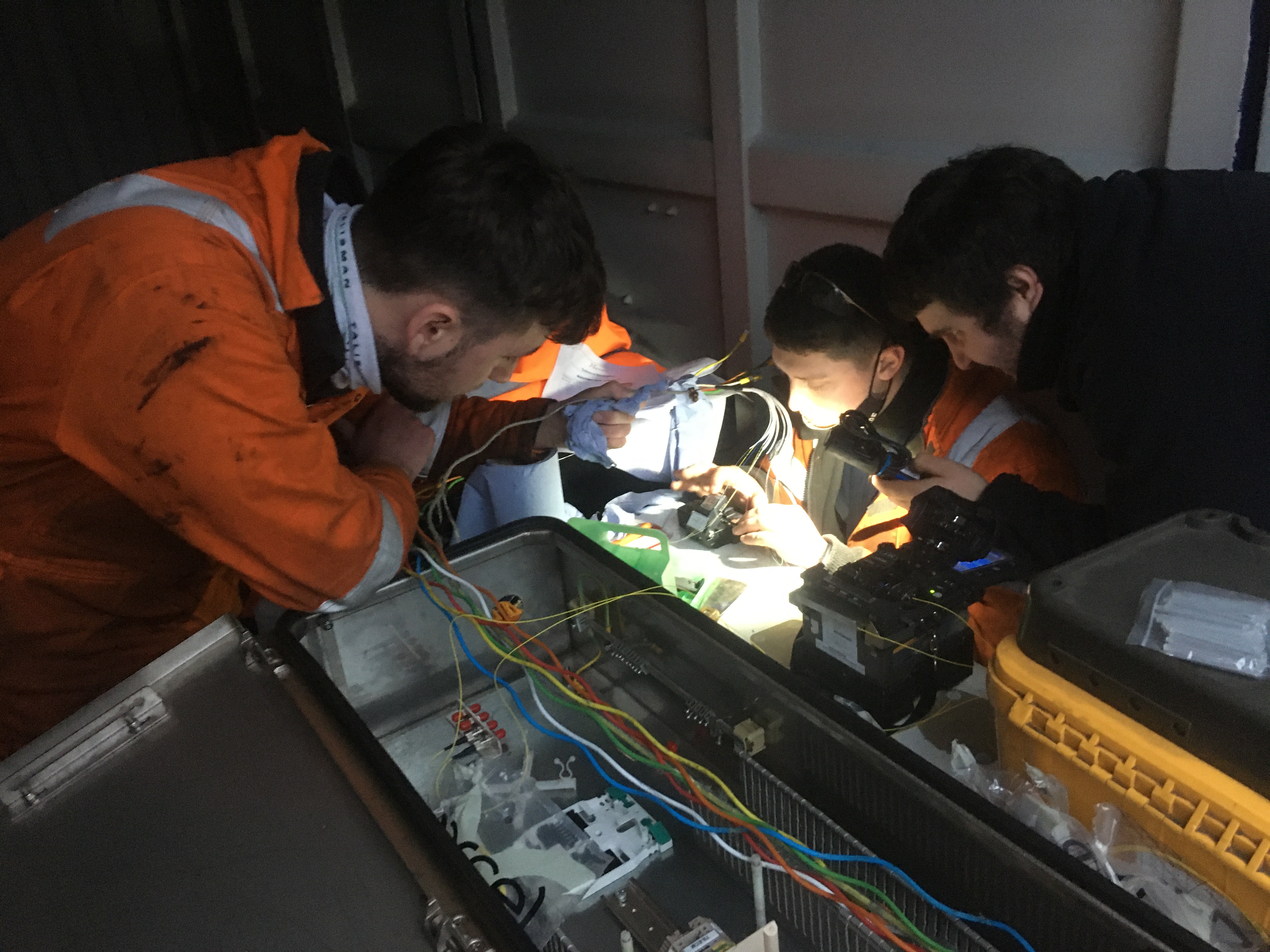 Three engineers performing repair