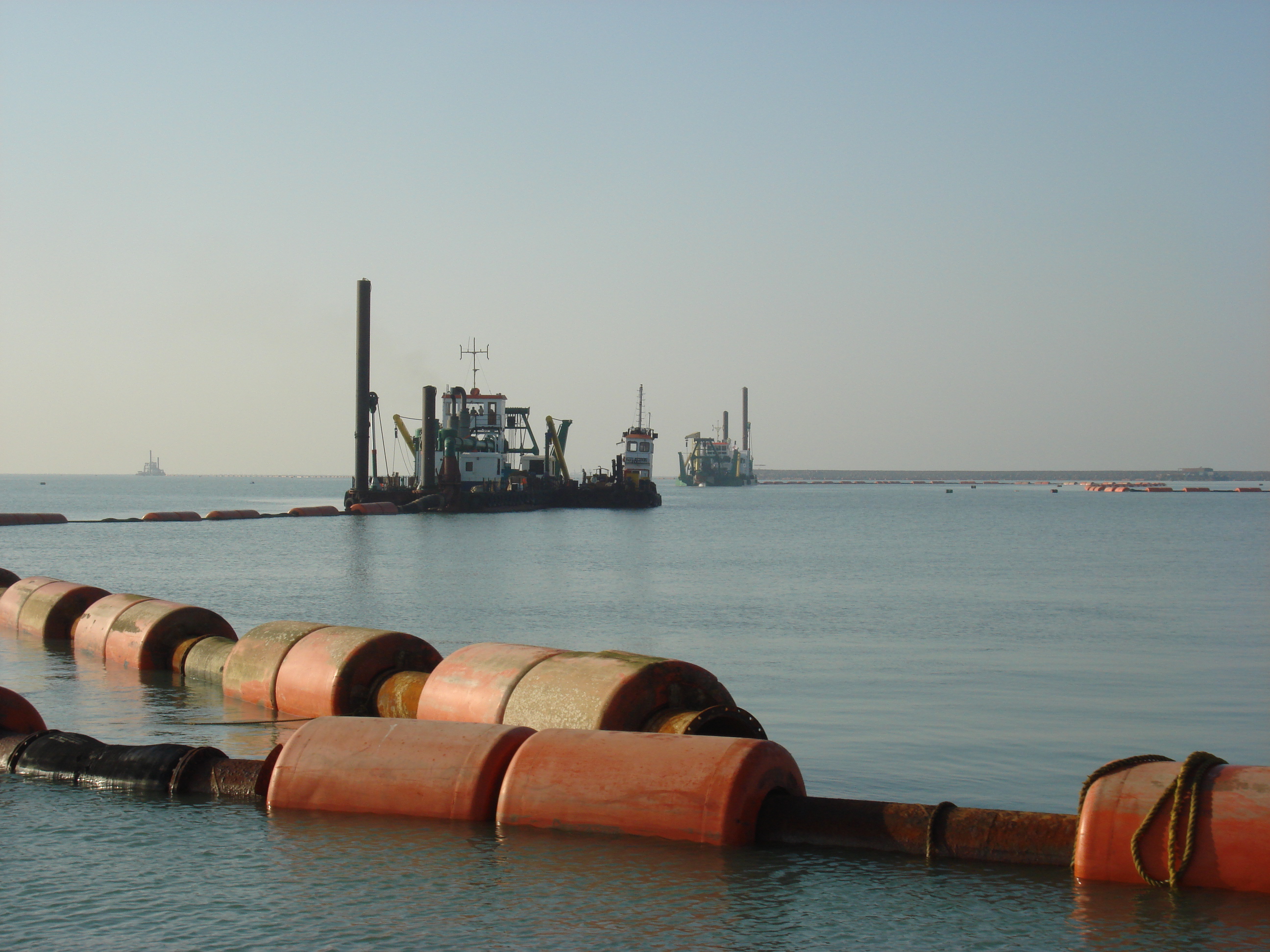 Two cutter suction dredger shore pumping soil to create new land