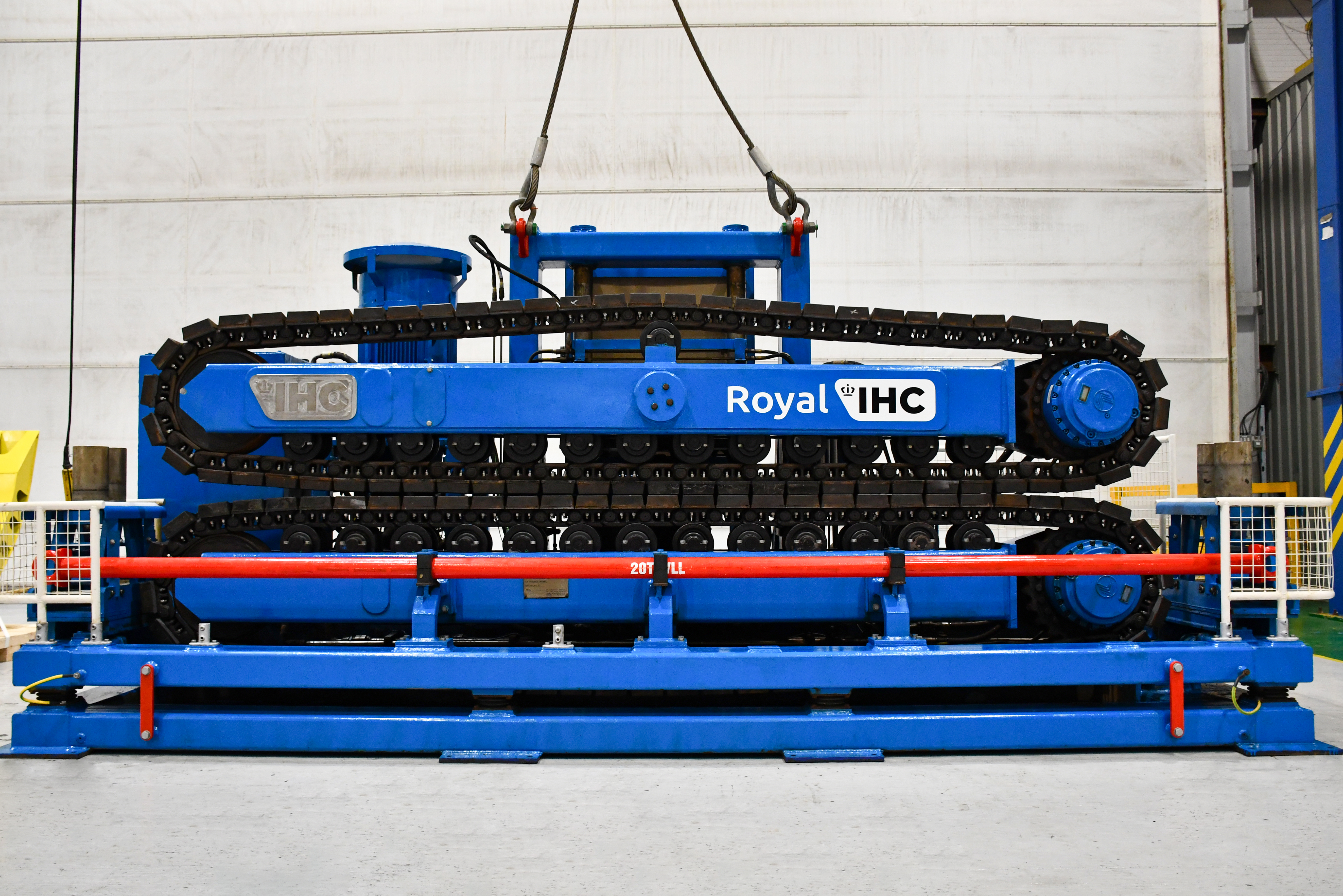Blue tracked cable tensioner in a clean factory setting
