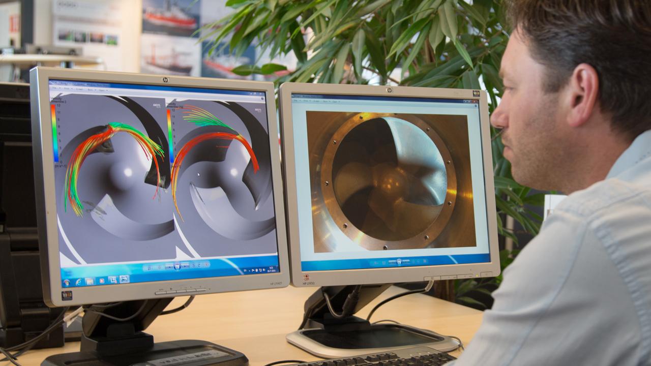 engineer sitting at desk looking at drawings and calculations