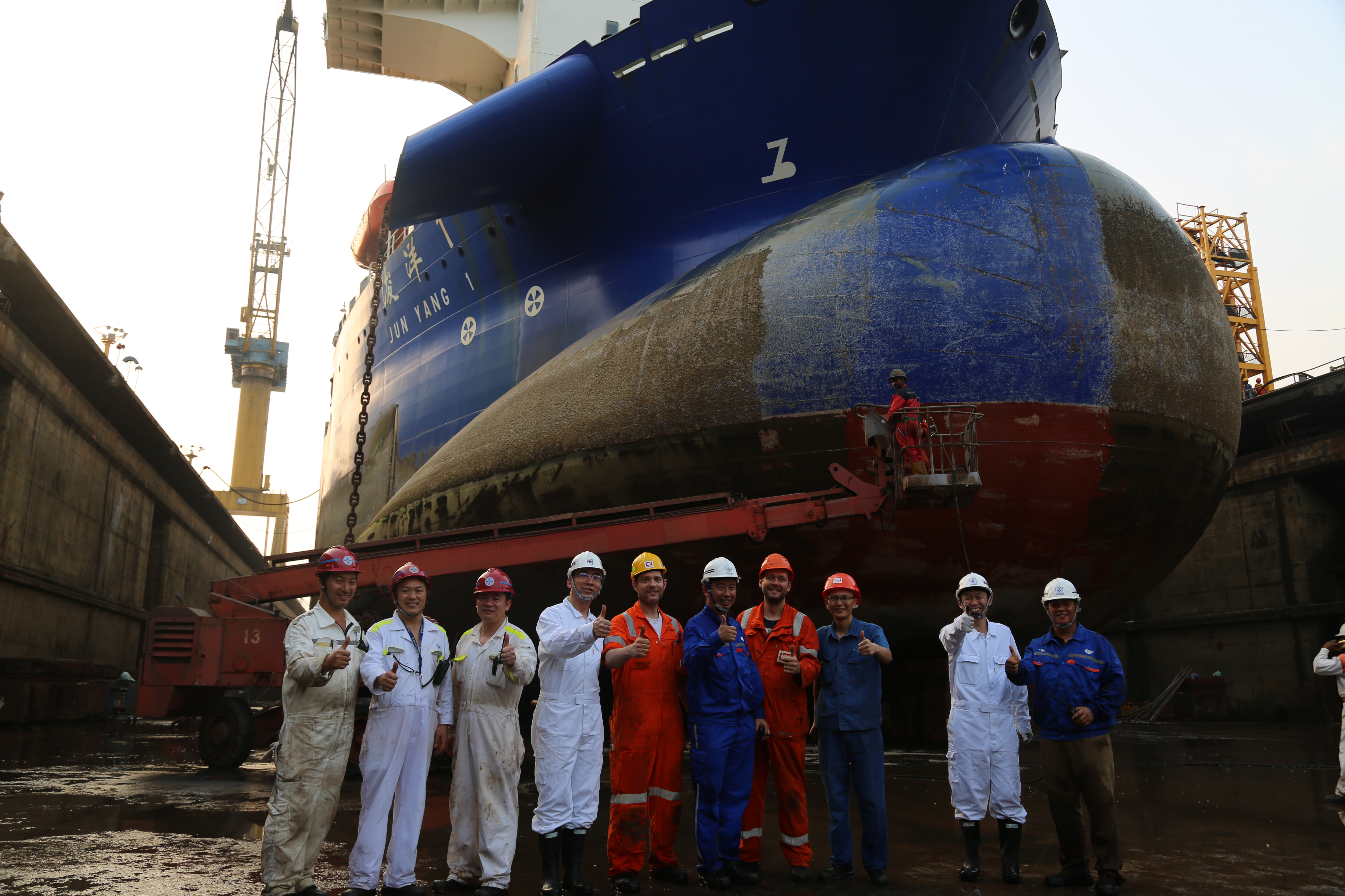 service team in front of dredging vessel