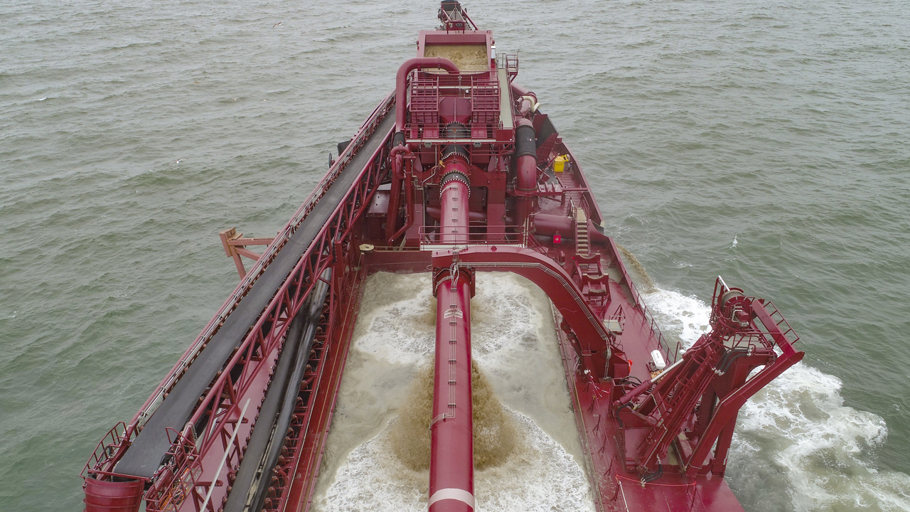 Gravel dredger in action with screening and hopper loading of aggregates 