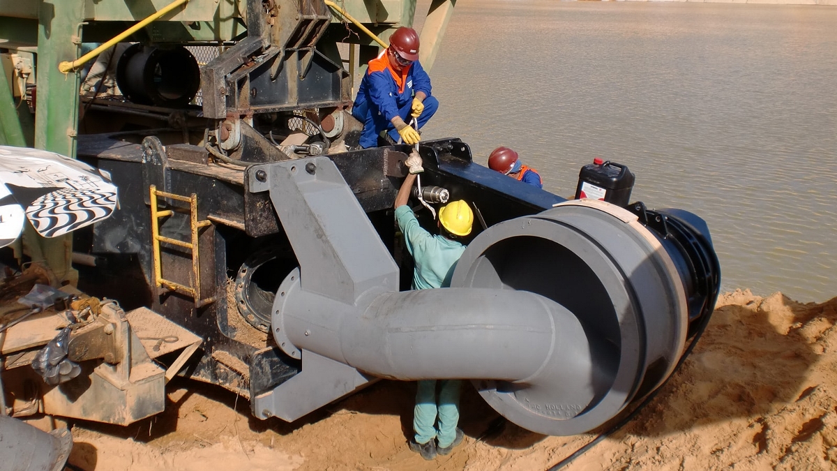 Men working on equipment on shore